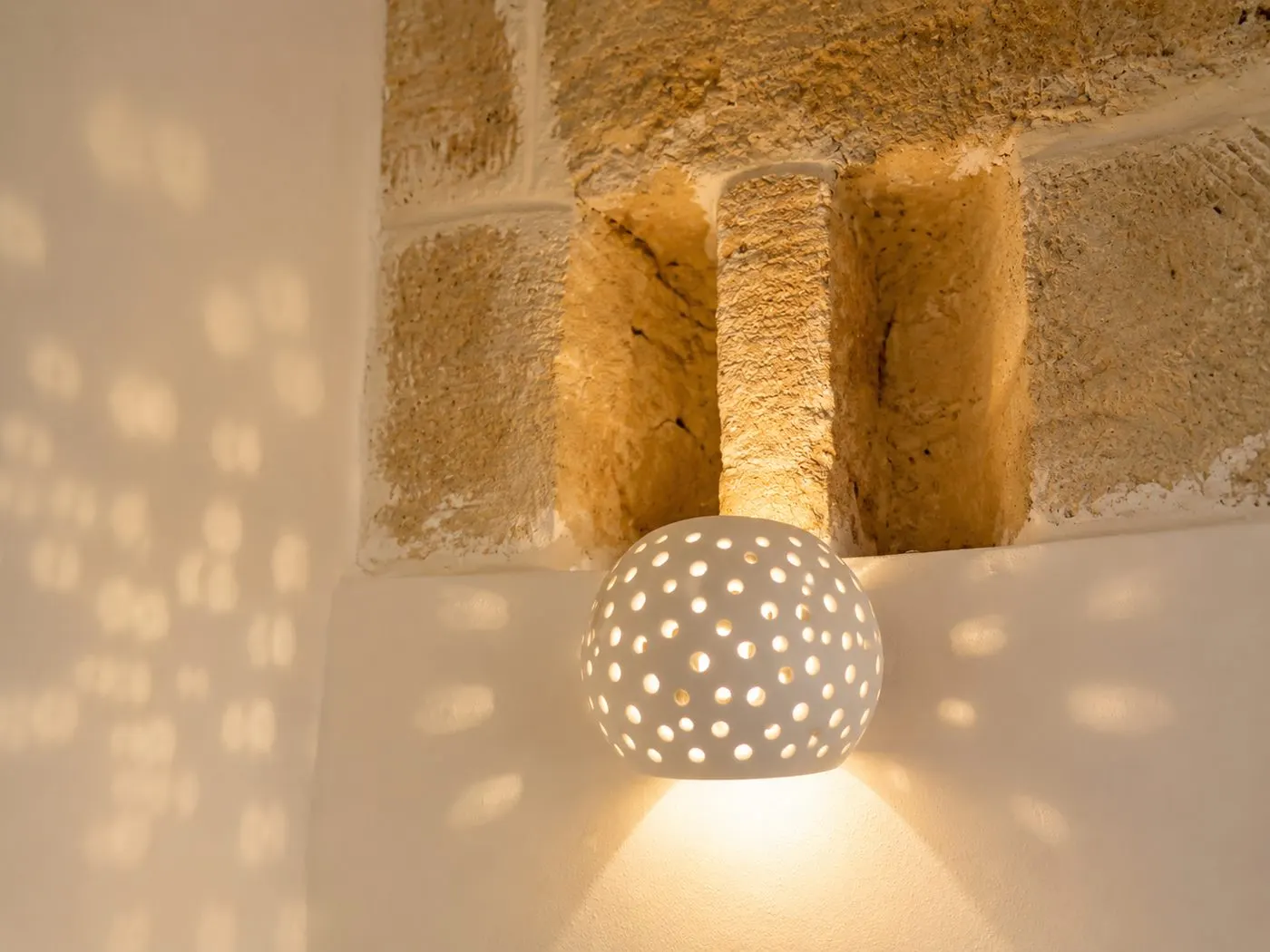 Dettaglio lampada e pietra a vista